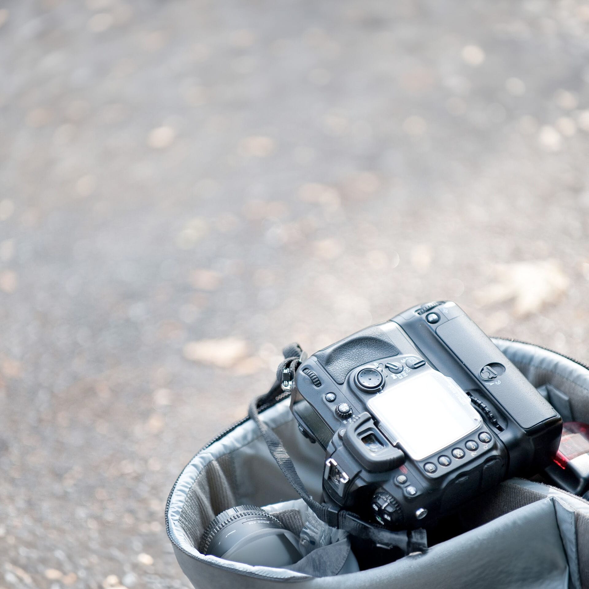 Camera in open bag on floor