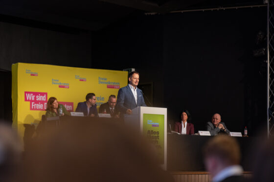Political speech at FDP event with several speakers.