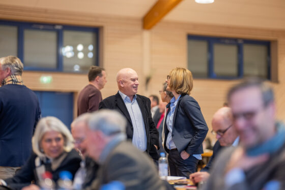 People talking in a meeting hall.