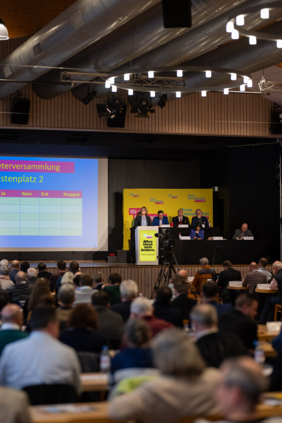 Conference with presentation and participants in the hall.