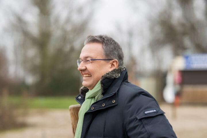 Smiling man outside in winter coat