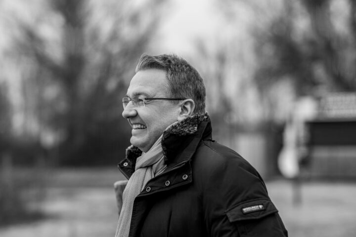 Smiling man outdoors, winter jacket and scarf