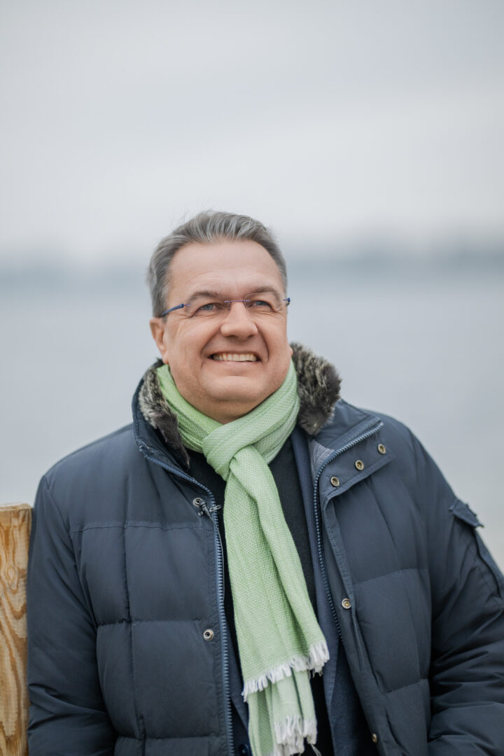 Smiling man with scarf outdoors