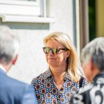 Person bei Gespräch draußen mit Sonnenbrille