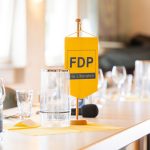 FDP-Logo auf gelbem Tischbanner
