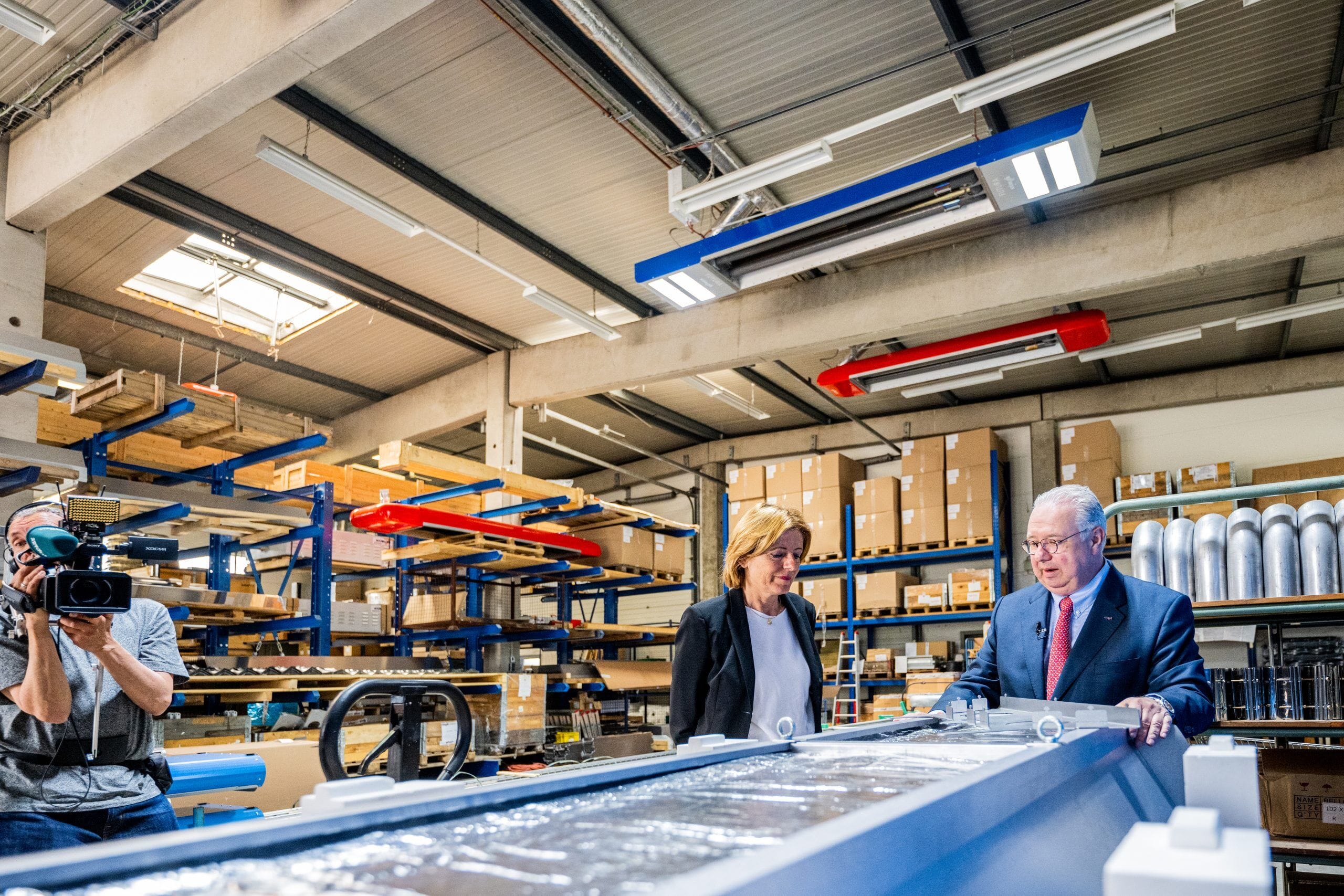 People in a warehouse with camera, daylight window